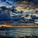 Sunset and rain clouds over  Sugar Loaf Marine Reserve in New Plymouth